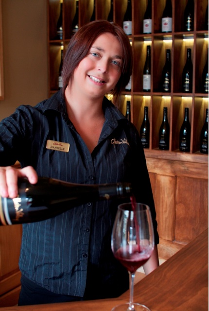 Danielle Carter of Gibbston Valley Winery pours a glass of the winery's celebrated pinot noir in the new tasting room in Arrowtown.